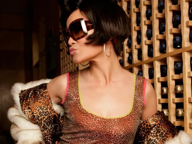 In this image we can see a lady wearing goggles and she has a short hair. On the right side of the...